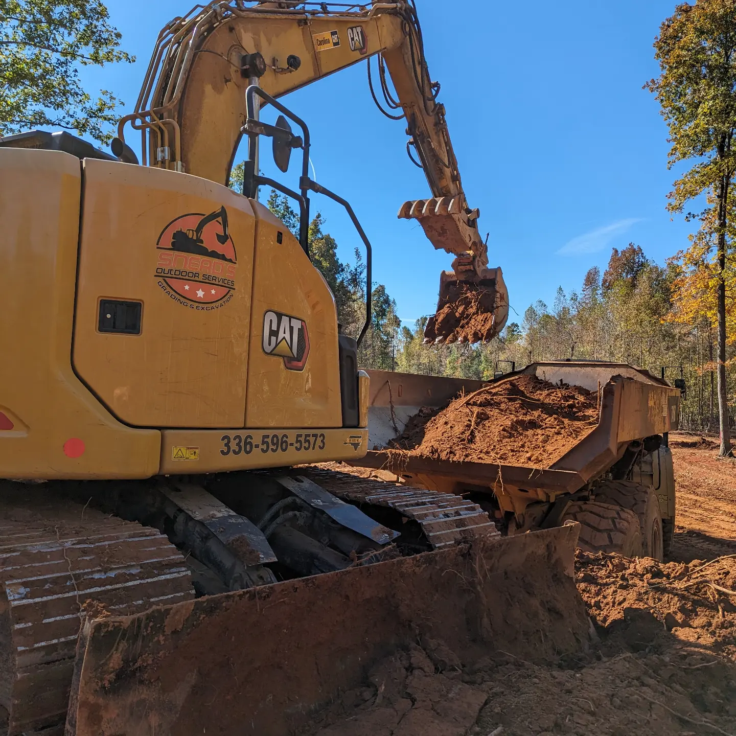 Wheel loader and crew finishing grade around new curbing