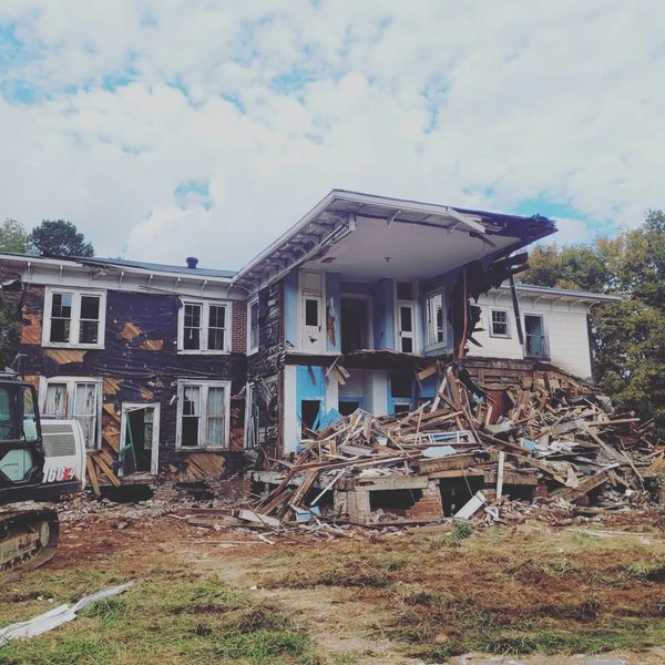 Two-storey house collapsed mid-demolition beside its debris pile