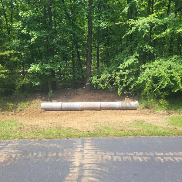 Culvert pipe staged on the verge before installation
