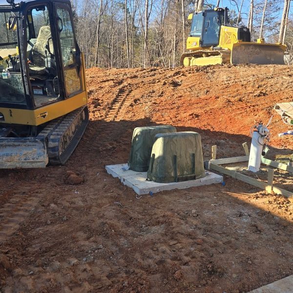 Septic tank set on its pad with the excavator still on site