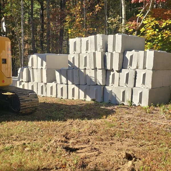 Concrete retaining blocks stacked for a wall build