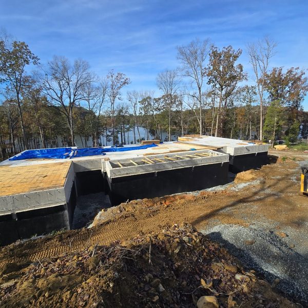 Concrete culvert structure set at a lake edge with stone protection