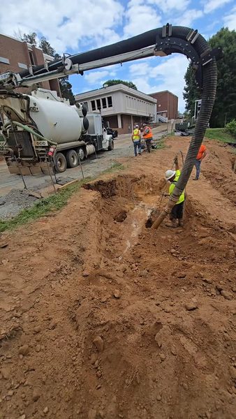 Vacuum excavation truck working a trench with the crew alongside