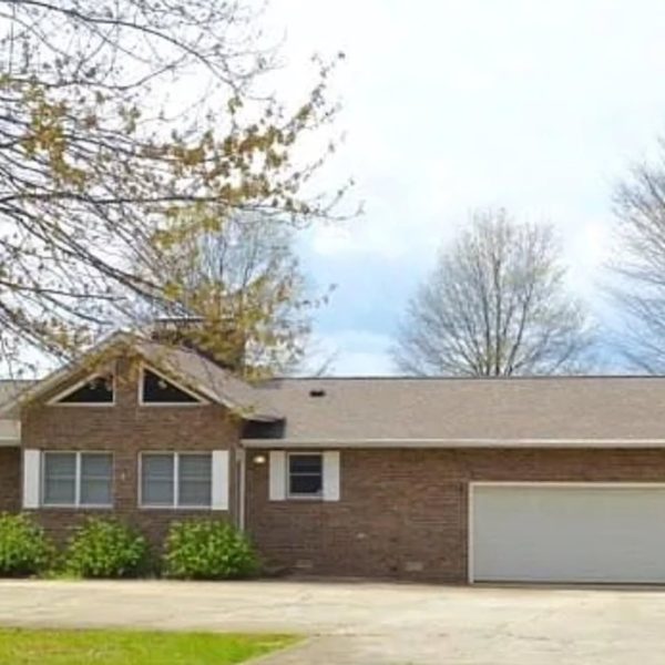 Brick ranch house with attached garage before demolition