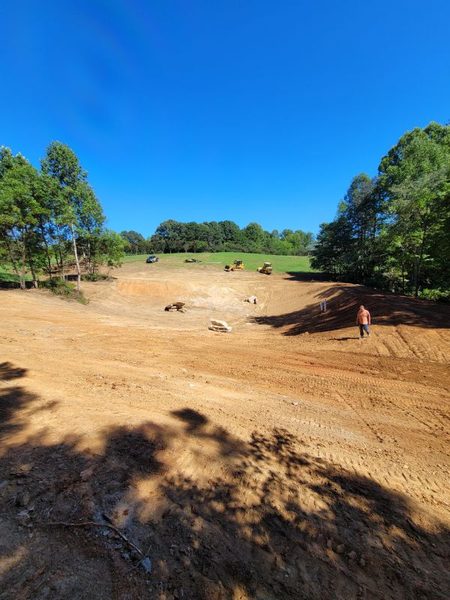 Pond basin graded out, with the crew working the far bank