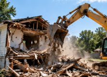 Excavator taking down a house during a central North Carolina demolition