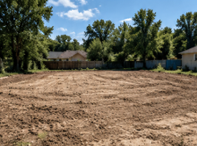 Cleared and graded lot left behind after the structure and debris were hauled off